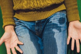 Leady having urinary incontinence wearing jeans and a jumper