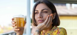 Woman drinking gut health drink Kombucha