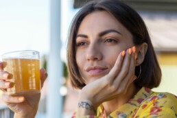Woman drinking gut health drink Kombucha